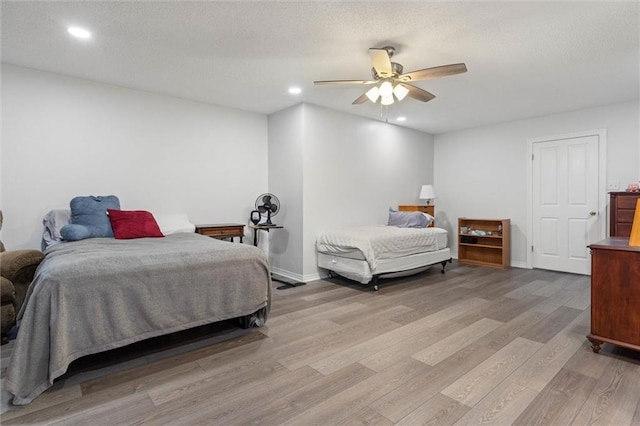 704 Providence Estates Dr E, Mobile, AL 36695 - bedroom featuring light wood-type flooring, recessed lighting, ceiling fan, a textured ceiling, and baseboards