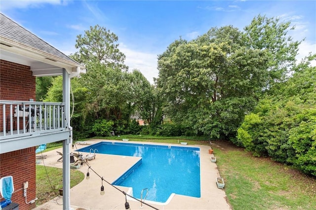 704 Providence Estates Dr E, Mobile, AL 36695 - swimming pool with a patio, a diving board, and view of wooded area