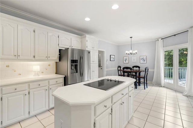 704 Providence Estates Dr E, Mobile, AL 36695 - kitchen with stainless steel fridge, black electric stovetop, light tile patterned flooring, white cabinetry, and ornamental molding