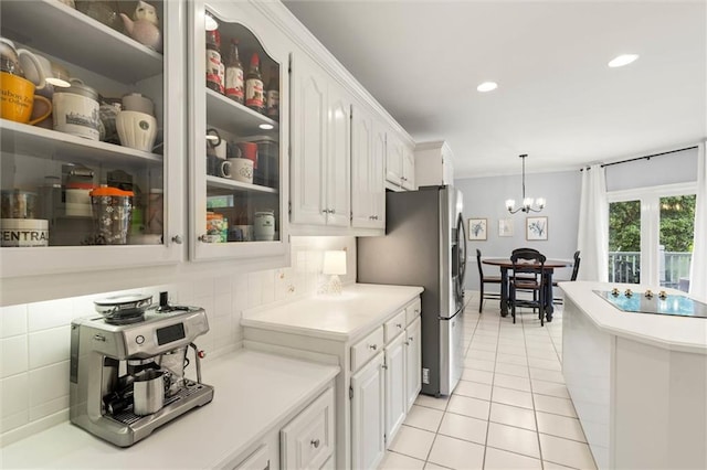 704 Providence Estates Dr E, Mobile, AL 36695 - kitchen featuring black electric stovetop, stainless steel fridge, light tile patterned flooring, white cabinets, and tasteful backsplash