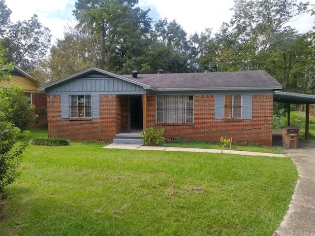 ranch-style home featuring a carport and a front yard