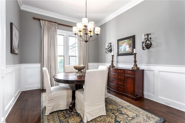 dining area with dark wood-type flooring, crown molding, and a chandelier