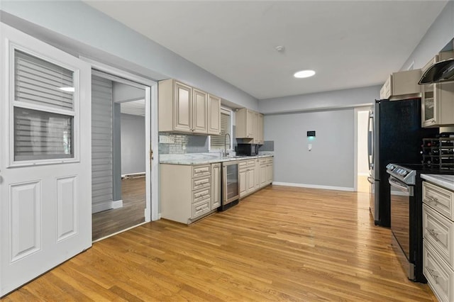 42 Lourando Dr W, Mobile, AL 36606 - kitchen featuring stainless steel electric range, wine cooler, light wood-type flooring, decorative backsplash, and wall chimney range hood