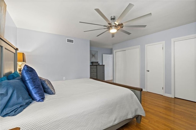42 Lourando Dr W, Mobile, AL 36606 - bedroom featuring multiple closets, wood finished floors, and ceiling fan
