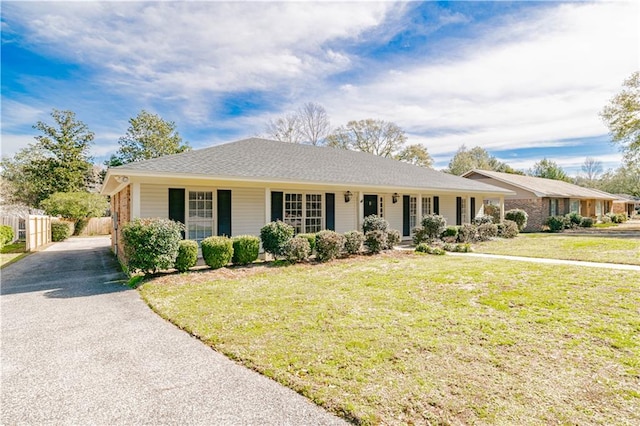 ranch-style house with a front lawn and a porch