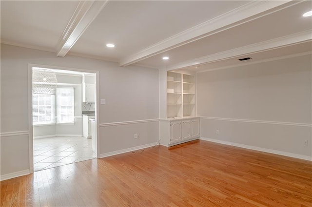 unfurnished room featuring beam ceiling and light hardwood / wood-style floors