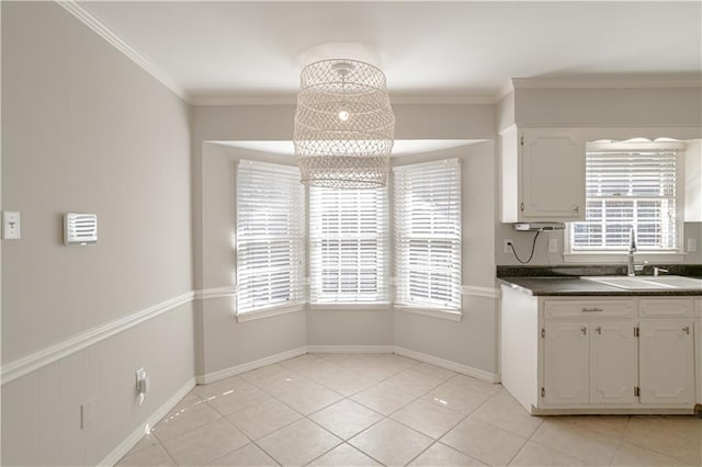 kitchen with sink, white cabinetry, and a healthy amount of sunlight