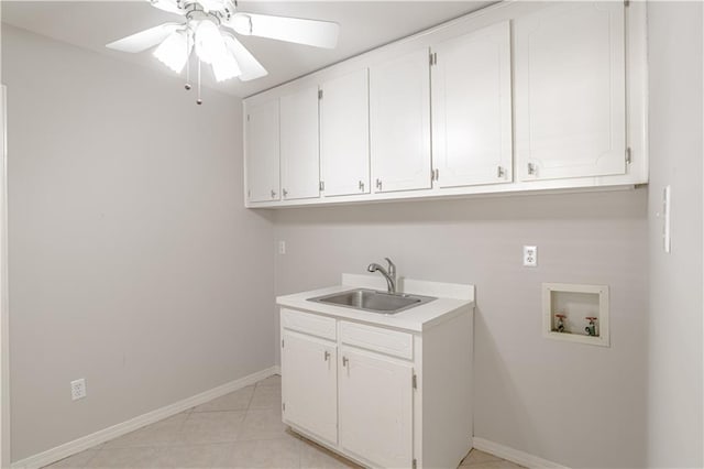 washroom with washer hookup, light tile flooring, ceiling fan, cabinets, and sink