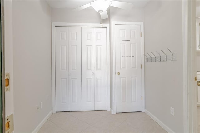 unfurnished bedroom featuring a closet, ceiling fan, and light tile flooring