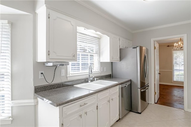 kitchen featuring plenty of natural light, white cabinetry, and sink