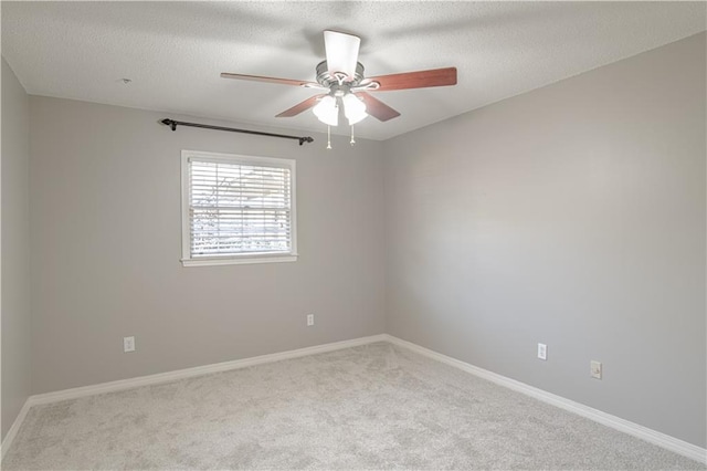 carpeted empty room featuring a textured ceiling and ceiling fan