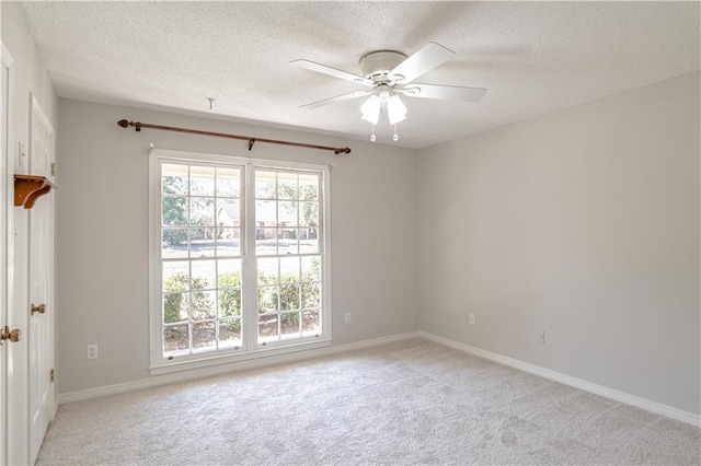 carpeted spare room with ceiling fan and a textured ceiling