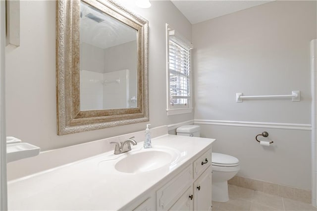 bathroom featuring tile flooring, toilet, and large vanity