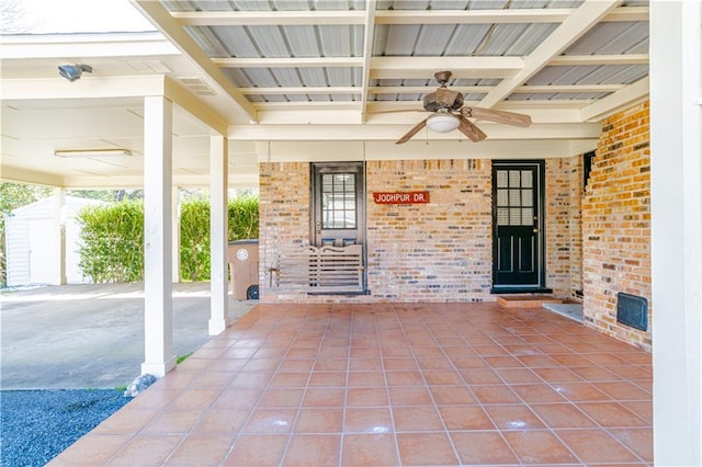 view of patio with ceiling fan and a storage shed