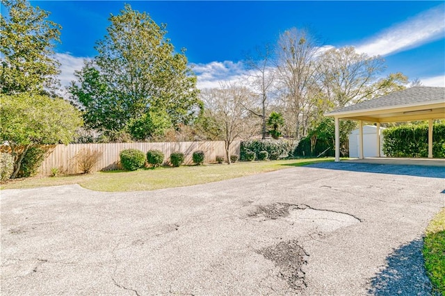 view of yard with a storage unit and a carport