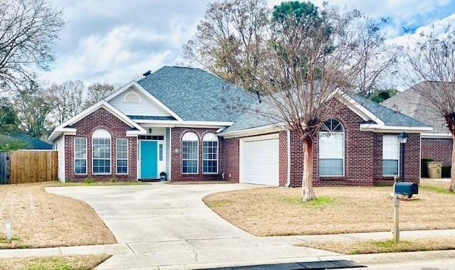 ranch-style house with a garage and a front yard