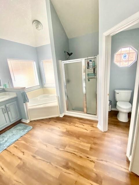 full bathroom with vaulted ceiling, plus walk in shower, hardwood / wood-style flooring, vanity, and toilet