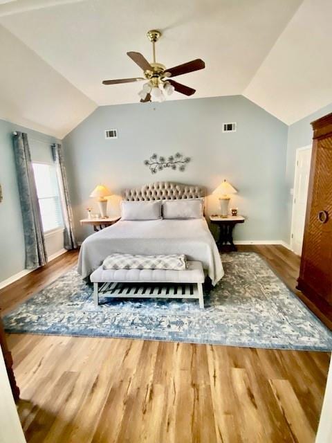 bedroom featuring ceiling fan, vaulted ceiling, and wood-type flooring