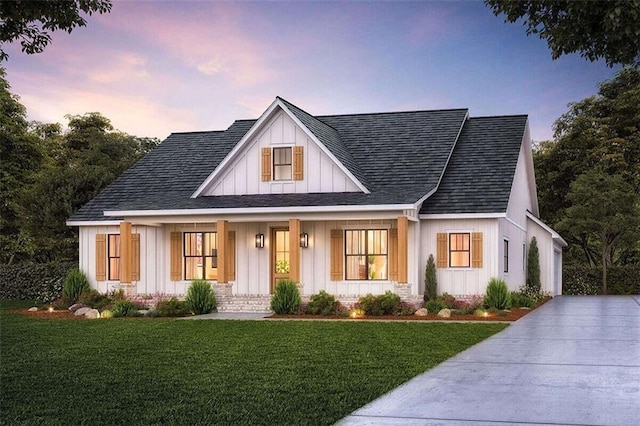 view of front of home featuring covered porch, board and batten siding, roof with shingles, and a front yard
