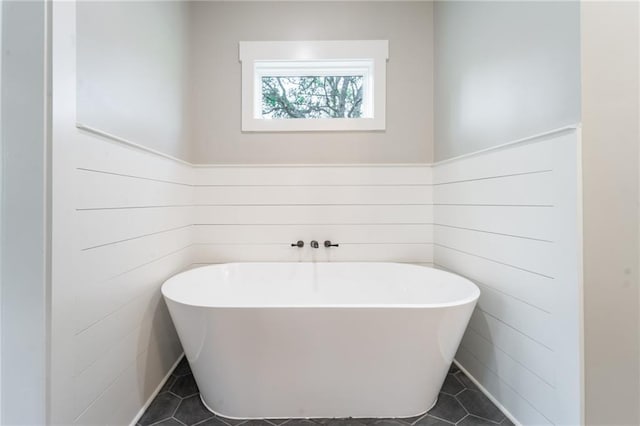 full bathroom with tile patterned floors and a soaking tub