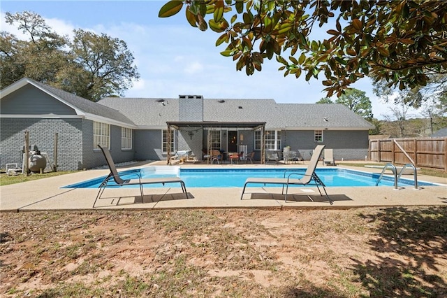 view of swimming pool featuring a fenced in pool, a patio area, and fence