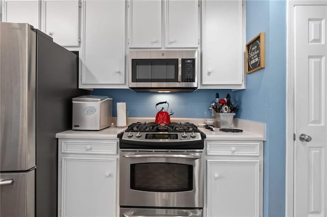 kitchen with light countertops, white cabinets, and appliances with stainless steel finishes