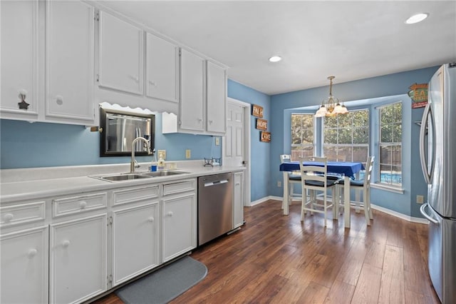 kitchen featuring a sink, light countertops, stainless steel appliances, white cabinetry, and dark wood-style flooring