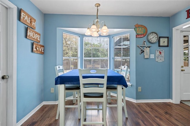 dining room featuring baseboards, an inviting chandelier, and wood finished floors