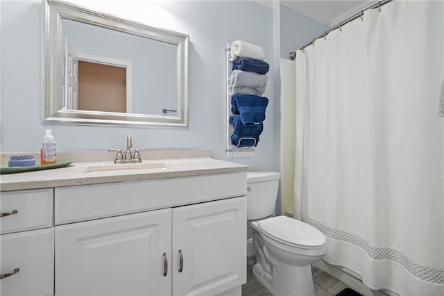 bathroom featuring curtained shower, toilet, and vanity