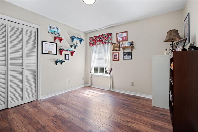 bedroom featuring a closet, baseboards, and wood finished floors