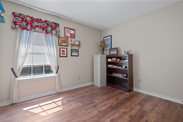 interior space featuring wood finished floors and baseboards