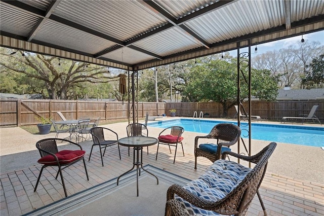 view of pool with a diving board, a fenced in pool, a patio, and a fenced backyard