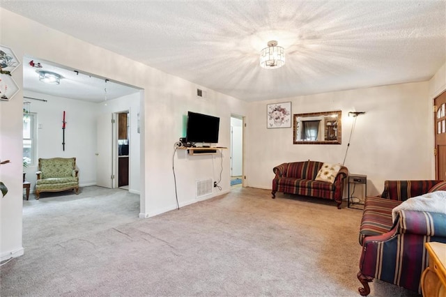 carpeted living room with a textured ceiling