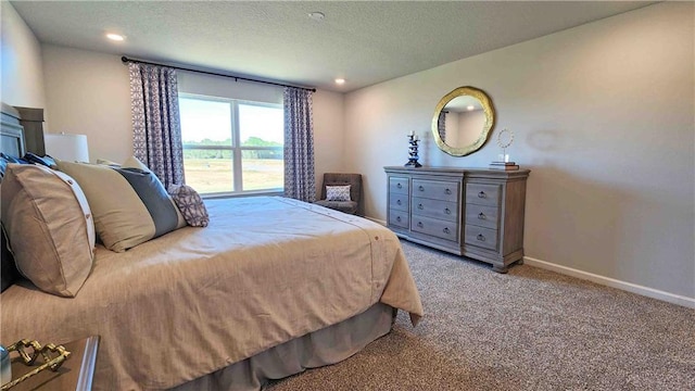 bedroom featuring a textured ceiling, baseboards, carpet floors, and recessed lighting