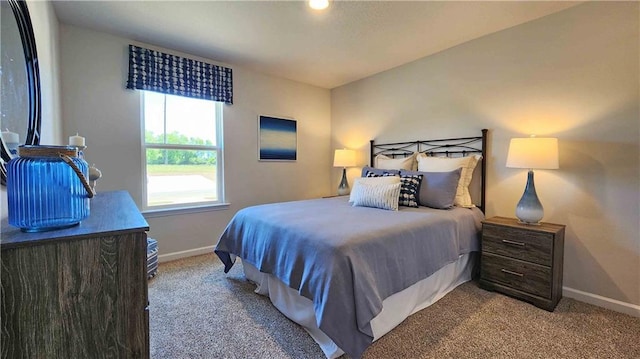 carpeted bedroom featuring baseboards