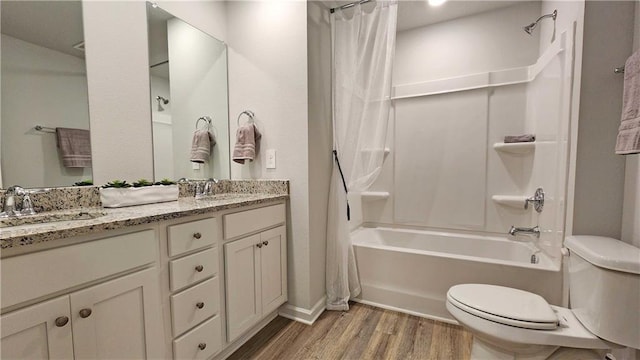 full bathroom featuring a sink, double vanity, toilet, wood finished floors, and shower / bathtub combination with curtain