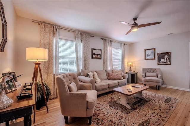 living room with light hardwood / wood-style floors and ceiling fan