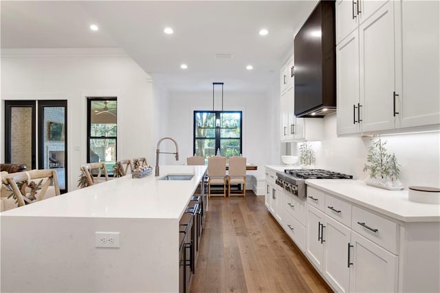 kitchen featuring a wealth of natural light, stainless steel gas cooktop, a large island, and sink