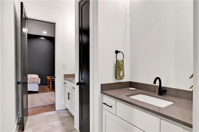 bathroom featuring hardwood / wood-style floors, vanity, and crown molding