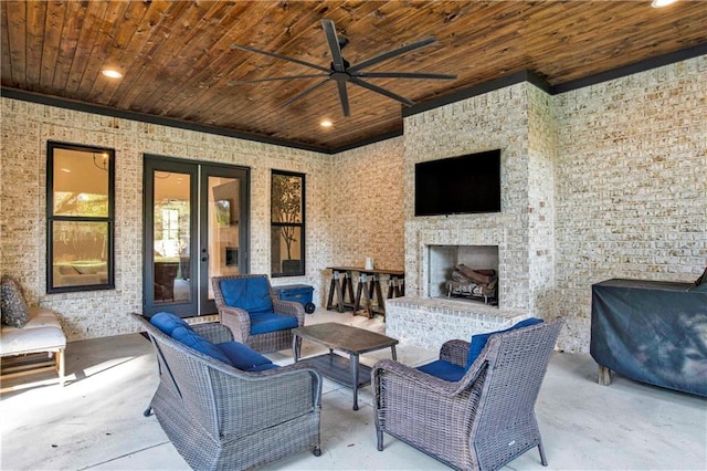 view of patio / terrace with an outdoor living space with a fireplace and ceiling fan