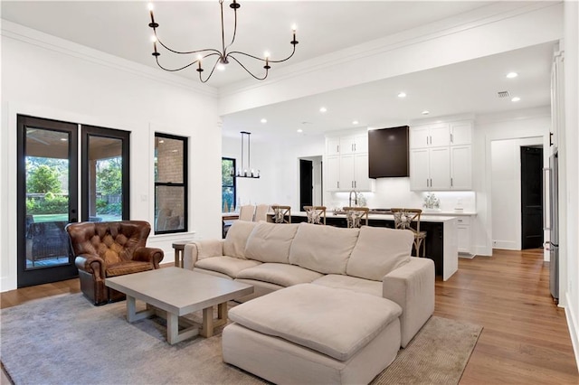 living room featuring light hardwood / wood-style floors and crown molding