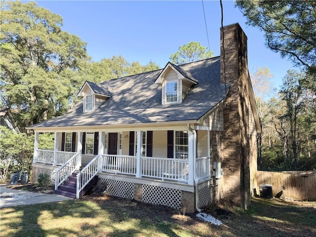 cape cod home featuring covered porch and cooling unit