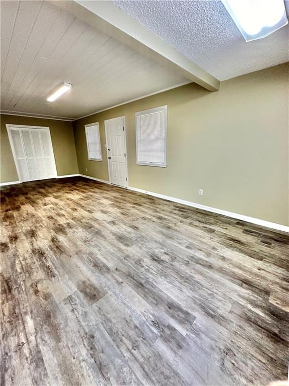 spare room with a textured ceiling and wood-type flooring