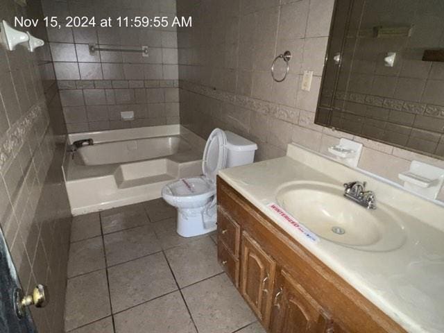 full bathroom with bathtub / shower combination, tile patterned floors, toilet, vanity, and tile walls