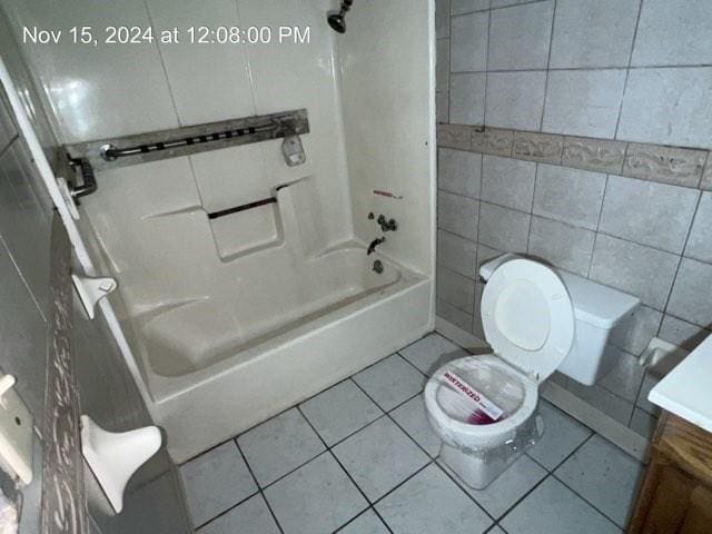 full bathroom featuring vanity, tile patterned floors, toilet, tile walls, and shower / bath combination