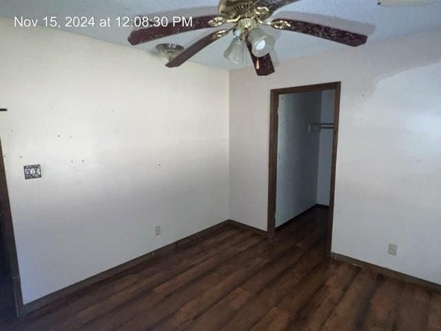 unfurnished room featuring ceiling fan and dark wood-type flooring