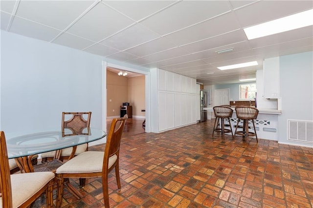 6659 Viking Way, Mobile, AL 36582 - dining space with a drop ceiling and brick patterned flooring