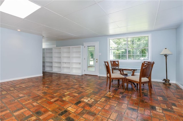 6659 Viking Way, Mobile, AL 36582 - dining space featuring brick flooring and a drop ceiling