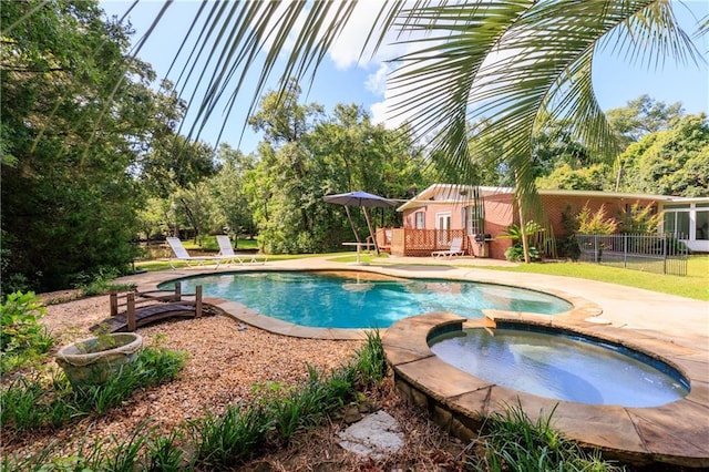 6659 Viking Way, Mobile, AL 36582 - view of pool featuring a pool with connected hot tub, a deck, a patio, and view of scattered trees
