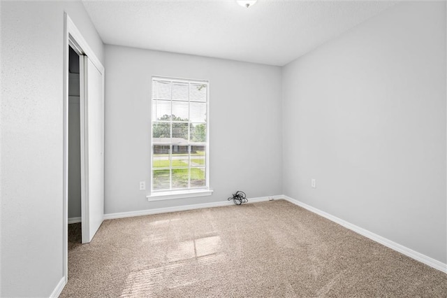 unfurnished bedroom featuring a closet and carpet